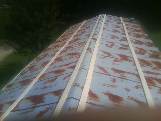 Rusted metal roof panels with new wood purlins before replacement — Storm Damage Roof Repair in Toccoa by Roofing Brothers